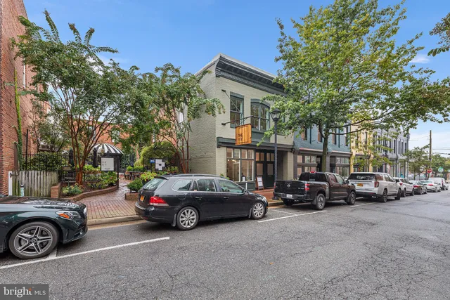 a view of a cars park in front of a house