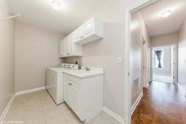 a view of a storage & utility room with cabinets