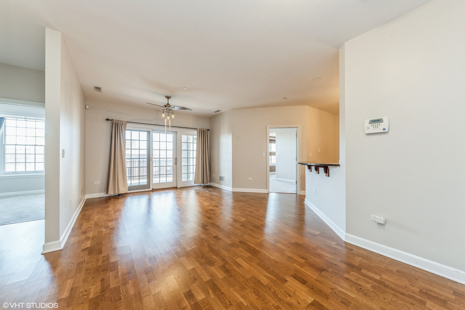50 North Plum Grove Road, Unit 501E Palatine, IL 60067 - Photo 3 of 11 wooden floor in an empty room with a window