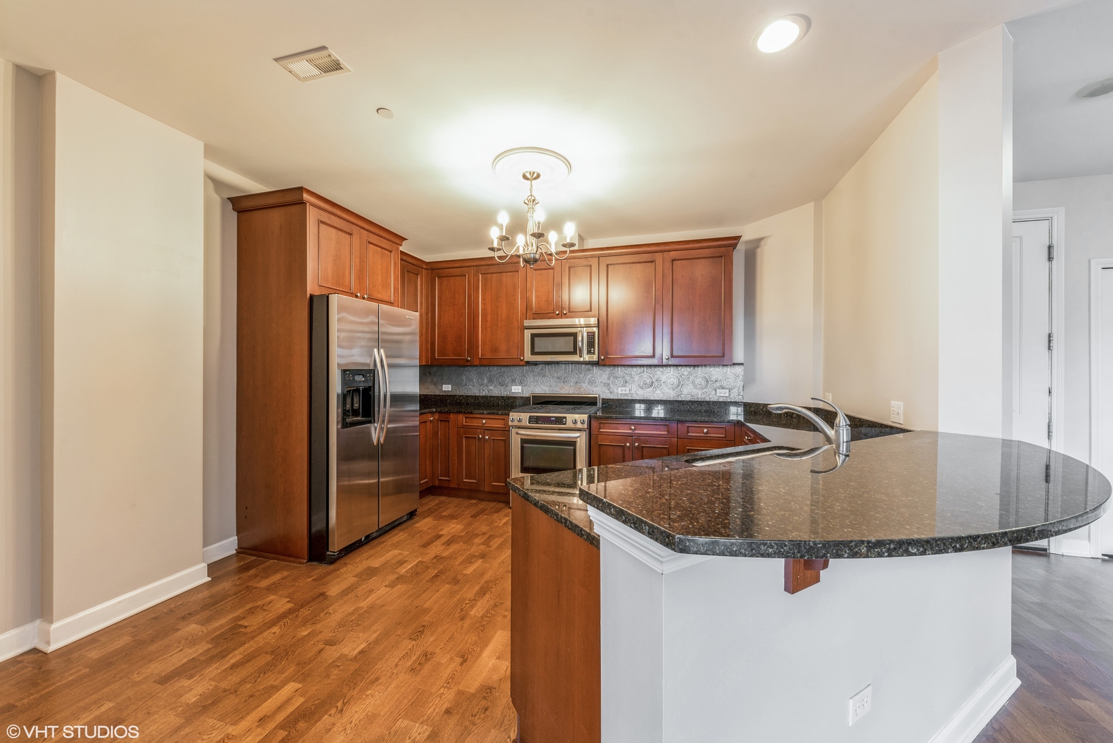 50 North Plum Grove Road, Unit 501E Palatine, IL 60067 - Photo 6 of 11 a kitchen with stainless steel appliances granite countertop a sink refrigerator and cabinets