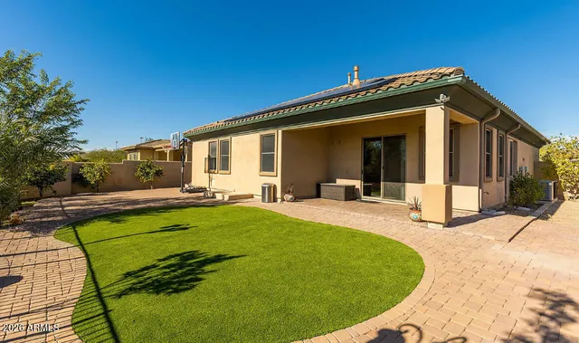 a view of a house with backyard and sitting area