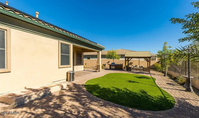 a view of a backyard with sitting area