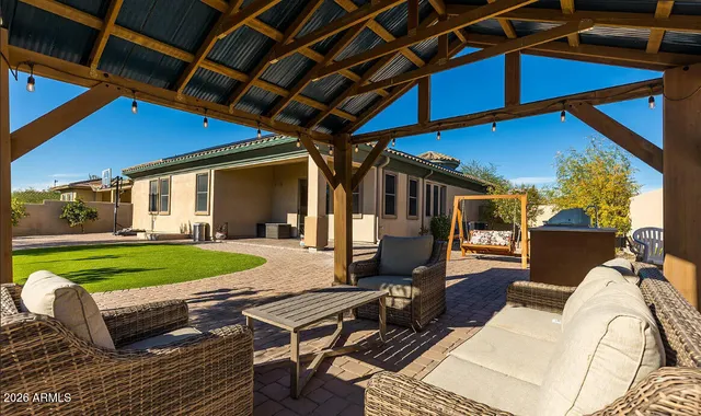 a backyard of a house with barbeque oven table and chairs