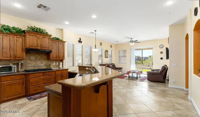 a kitchen with stainless steel appliances granite countertop a sink a stove and a refrigerator