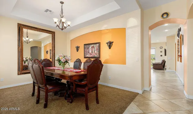 a view of a dining room with furniture and chandelier