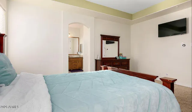 a bedroom with a bed and a flat screen tv