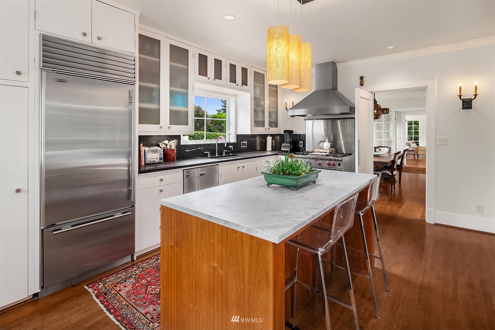 3915 East Pine Street Seattle, WA 98122 - Photo 12 of 32 a kitchen with stainless steel appliances granite countertop a kitchen island a stove a table and chairs