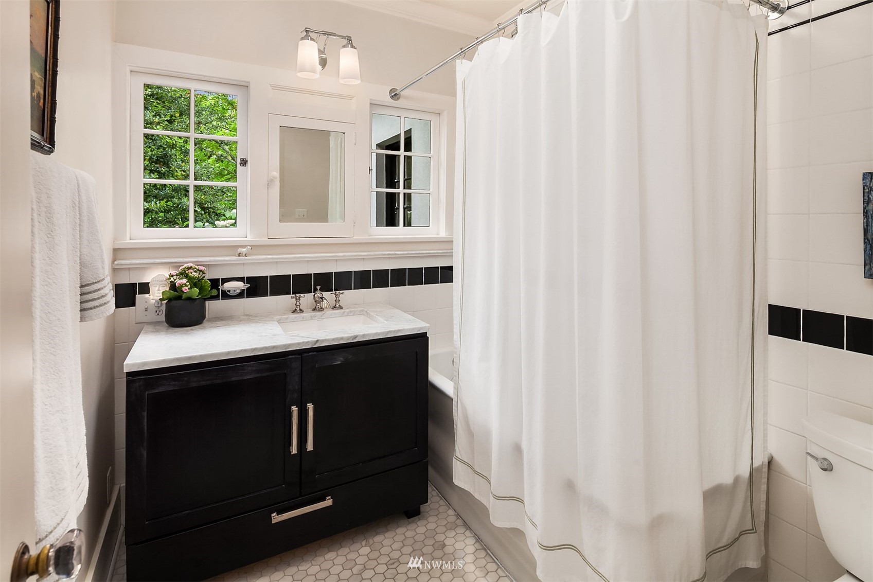 3915 East Pine Street Seattle, WA 98122 - Photo 22 of 32 a bathroom with a sink and a mirror