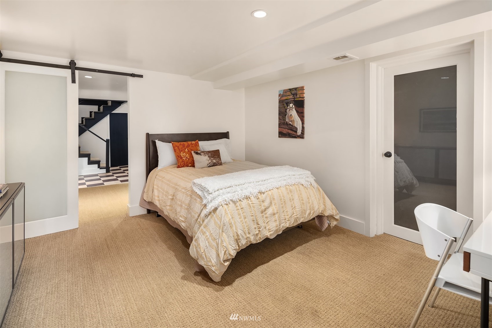 3915 East Pine Street Seattle, WA 98122 - Photo 25 of 32 a bedroom with a bed and a chair