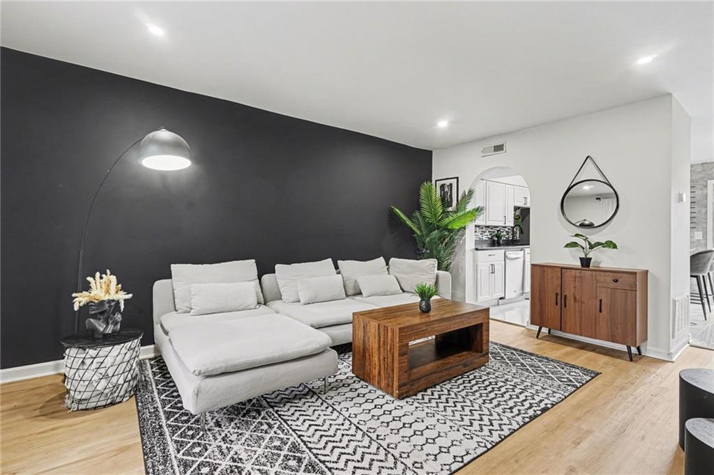a living room with furniture and wooden floor