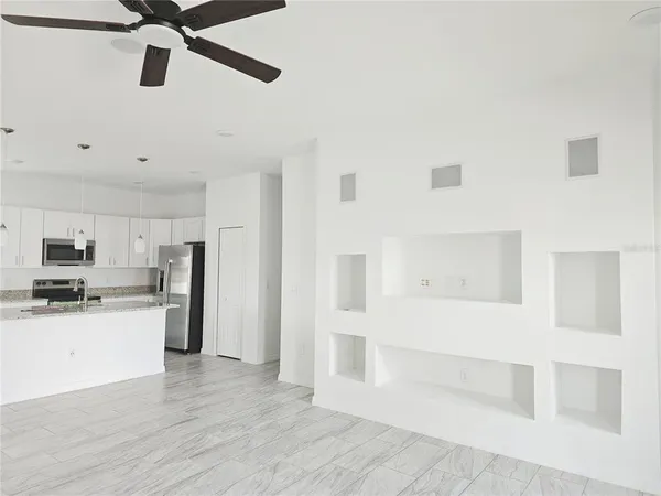 a kitchen with stainless steel appliances kitchen island granite countertop a refrigerator and a stove top oven