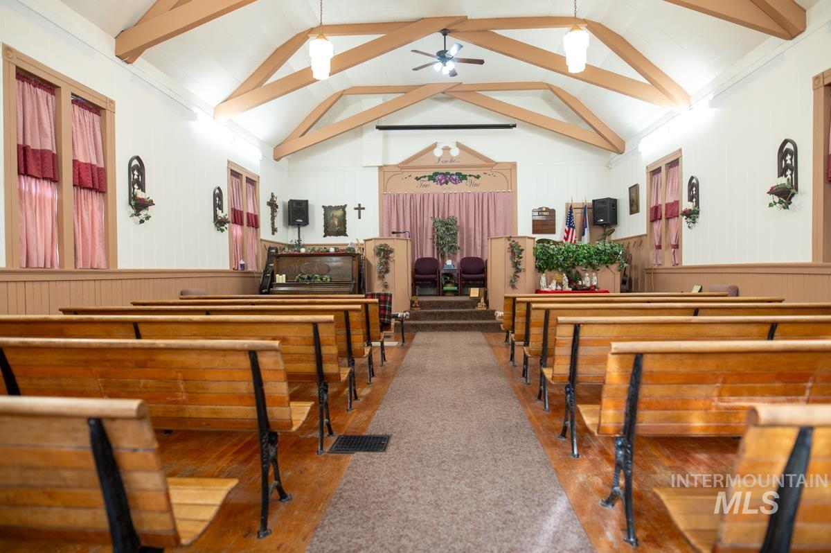 736 East Main Street Weiser, ID 83672 - Photo 6 of 17 Misc room featuring a ceiling fan, wooden walls, wainscoting, and beam ceiling