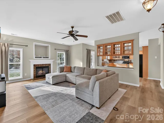 a living room with furniture and a ceiling fan