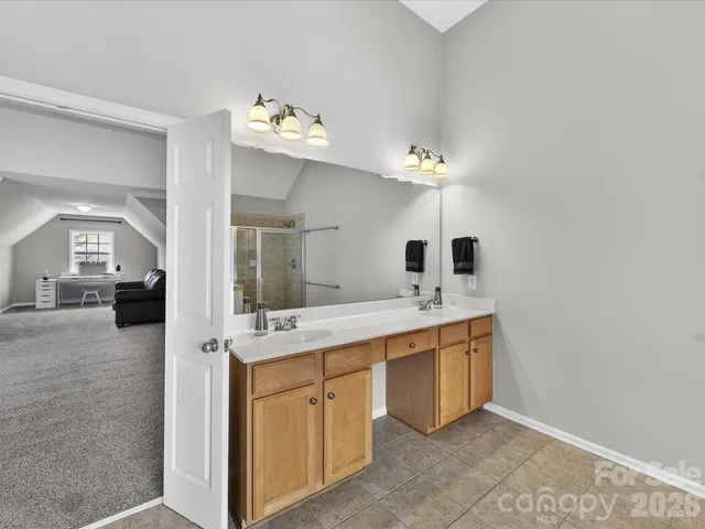 a bathroom with a tub sink and mirror