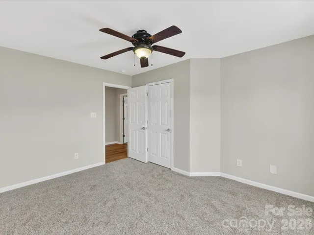 a bathroom with a sink a toilet and shower curtain