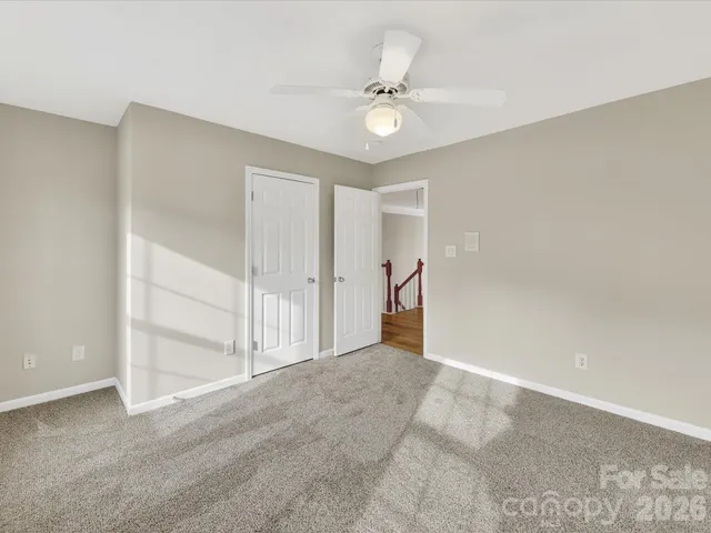 a spacious bedroom with a bed and a large window
