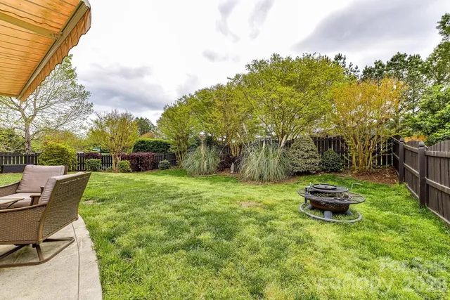 a backyard of a house with table and chairs