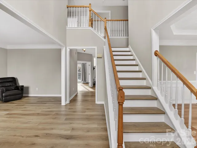 a view of room with stairs and wooden floor