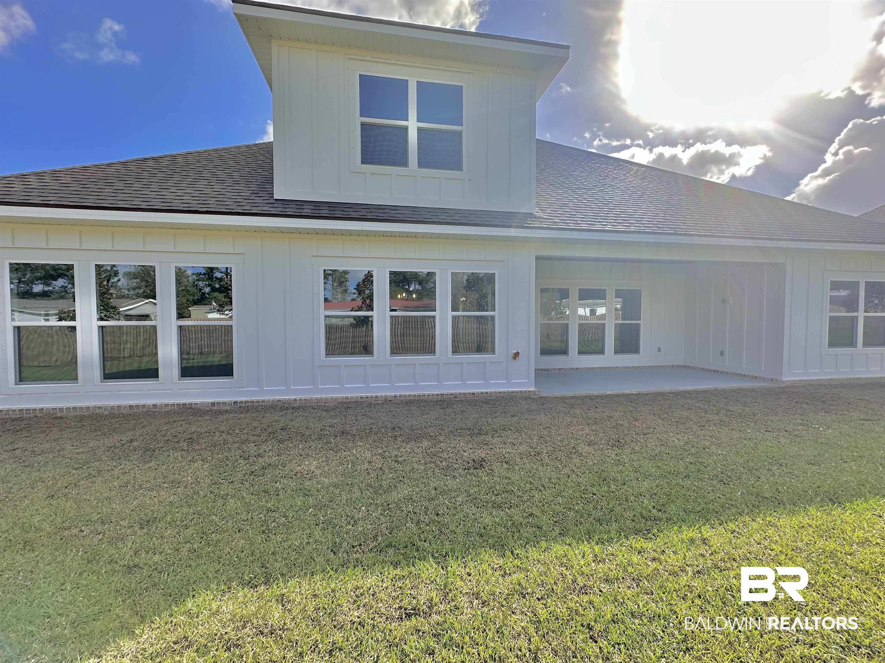 634 Kitfox Avenue Fairhope, AL 36532 - Photo 27 of 33 Rear view of house featuring a yard and a patio