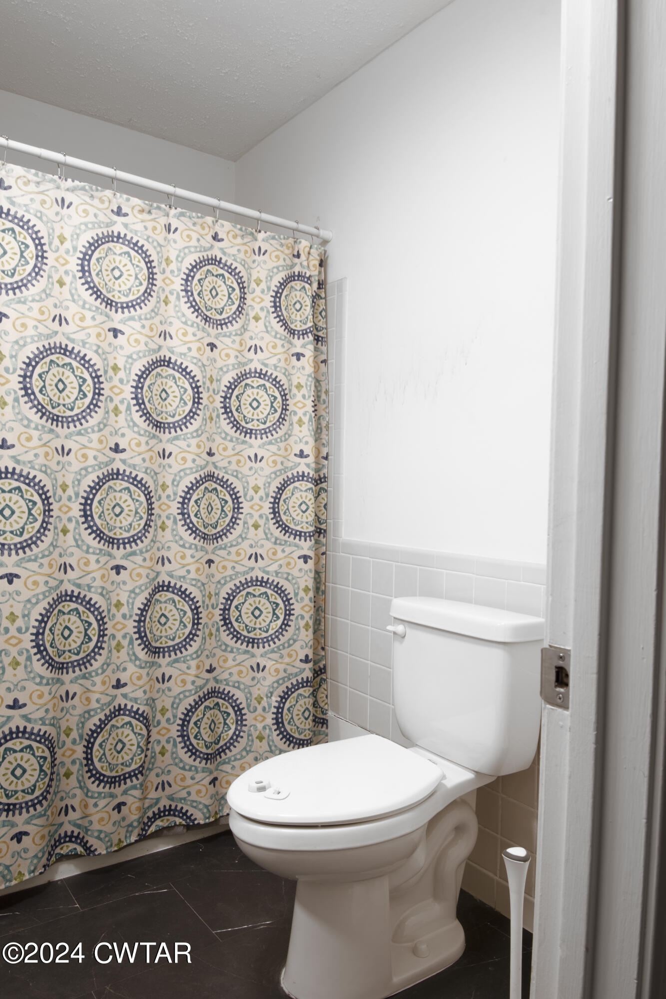 500 Paragon Mills Road Nashville, TN 37211 - Photo 10 of 14 a white toilet sitting next to a shower curtain