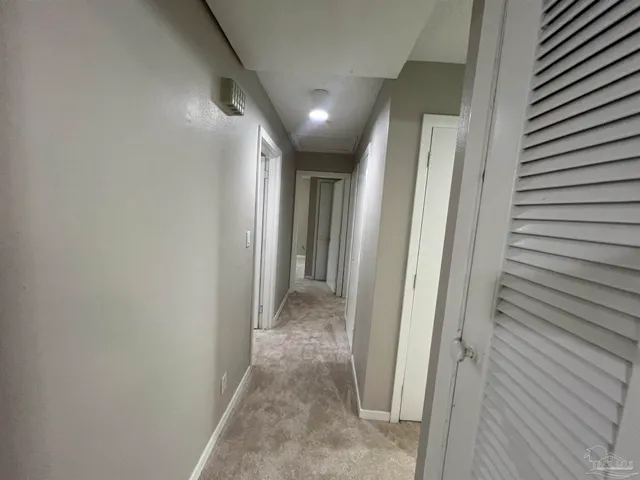 a view of a bathroom from a hallway