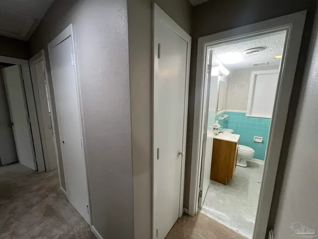 a bathroom with a sink mirror and toilet