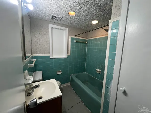 a bathroom with a sink mirror and vanity