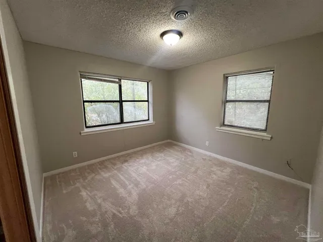 an empty room with closet and a fireplace