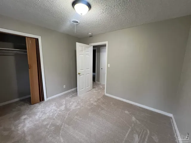 a backyard of a house with barbeque oven table and chairs