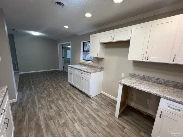 a kitchen with a sink and wooden cabinets