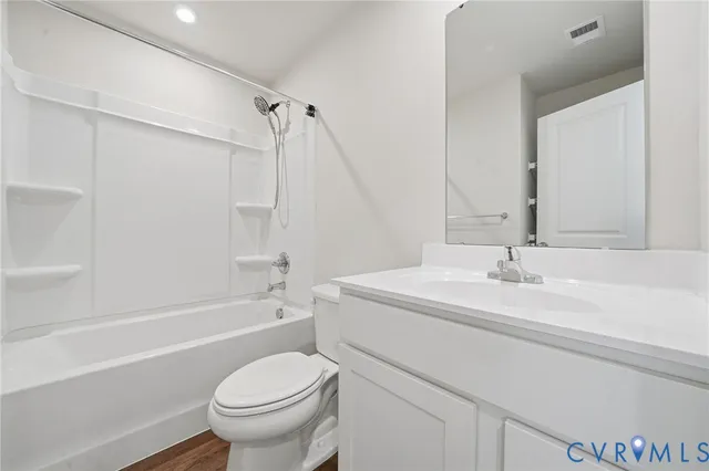 a bathroom with a sink toilet vanity and shower