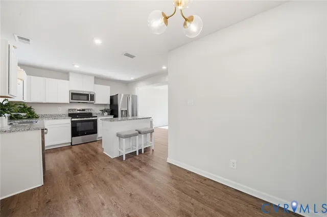 a kitchen with a sink stainless steel appliances and cabinets
