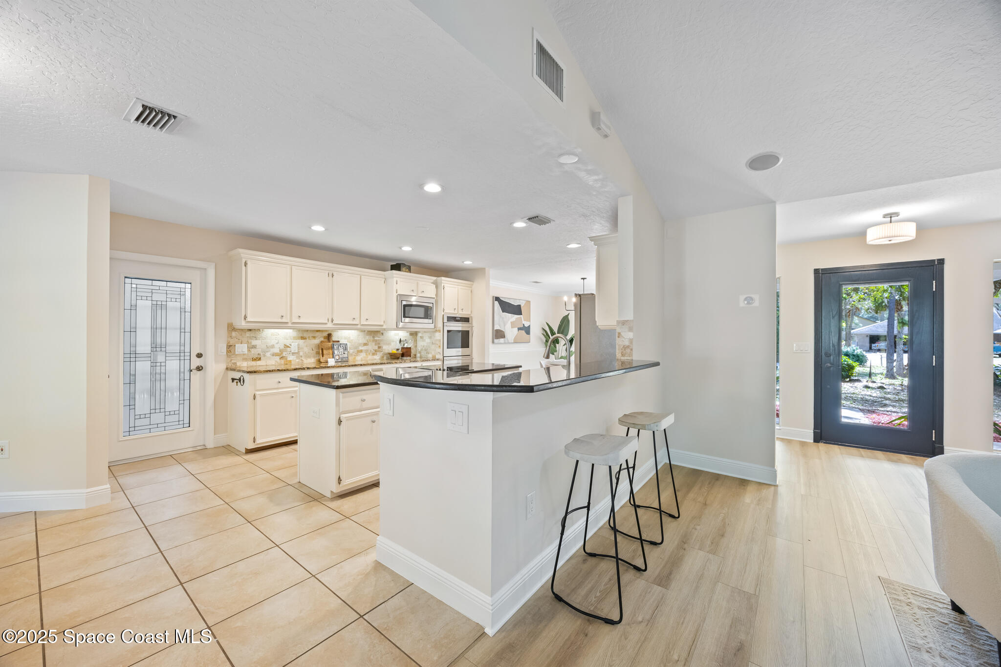 2190 Winston Drive Cocoa, FL 32926 - Photo 11 of 59 a kitchen with white cabinets and counter space