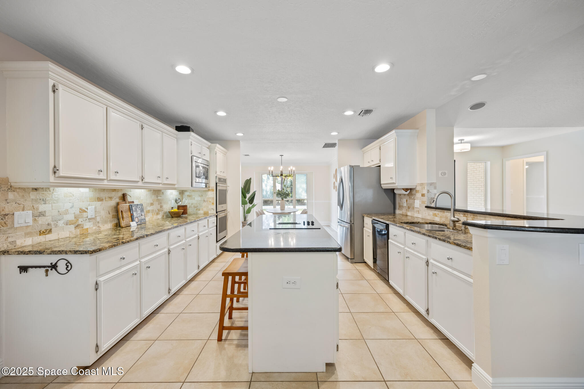2190 Winston Drive Cocoa, FL 32926 - Photo 13 of 59 a large kitchen with stainless steel appliances lots of counter top space cabinets and a sink