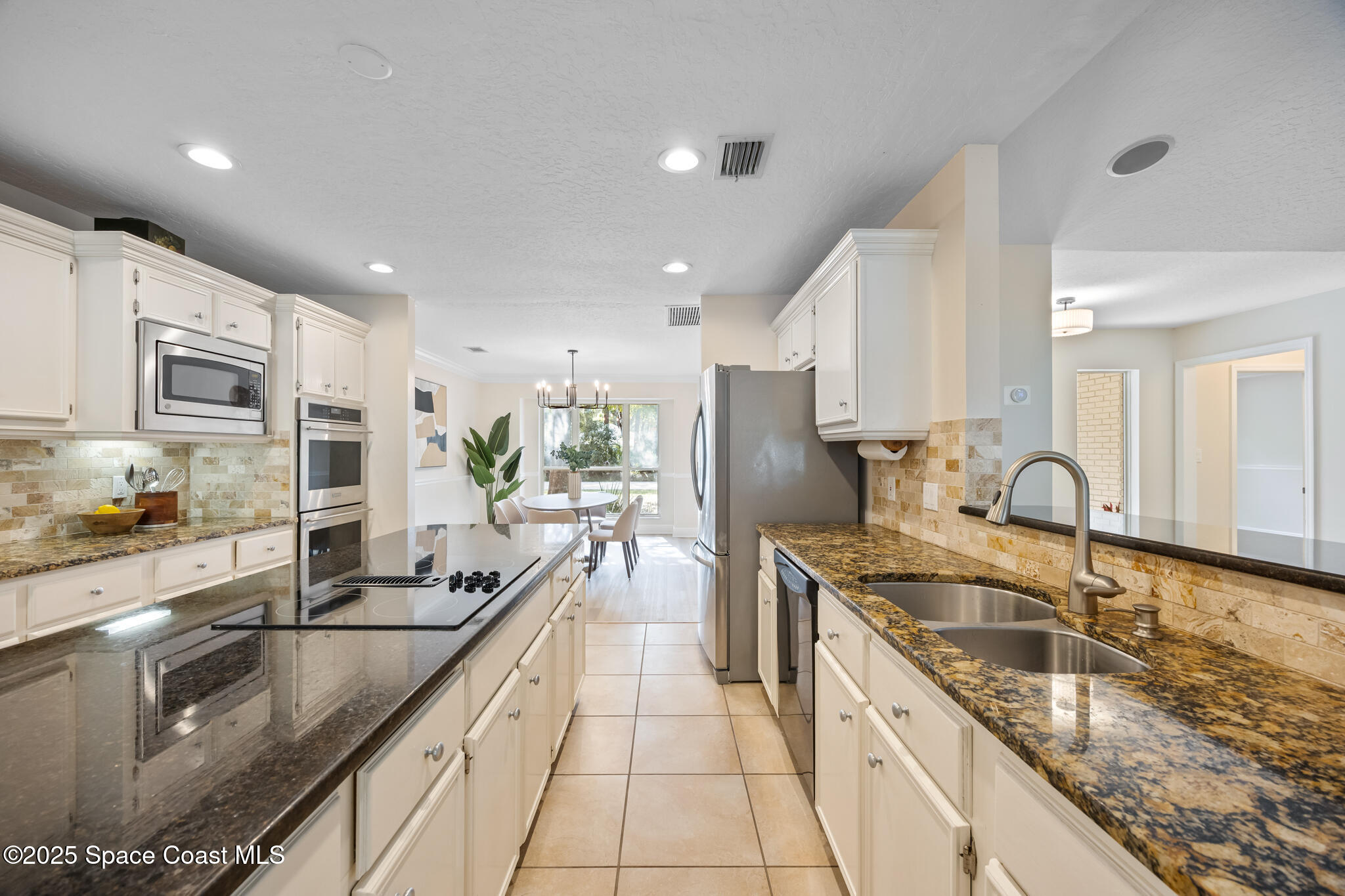 2190 Winston Drive Cocoa, FL 32926 - Photo 14 of 59 a kitchen with stainless steel appliances granite countertop a sink stove and refrigerator