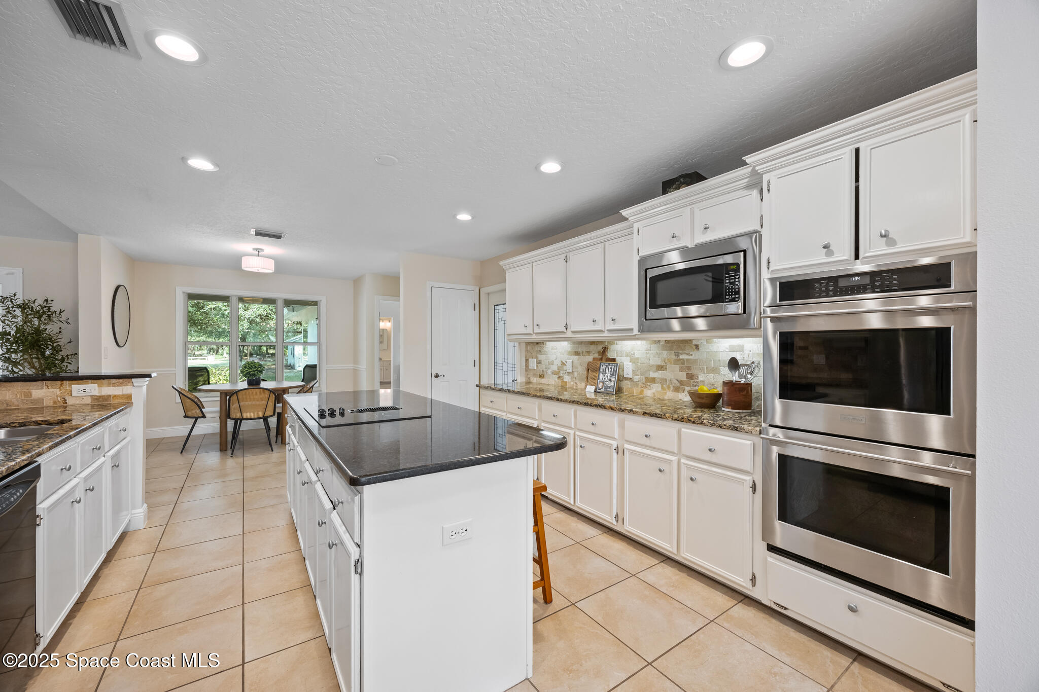 2190 Winston Drive Cocoa, FL 32926 - Photo 15 of 59 a kitchen with stainless steel appliances granite countertop a sink and cabinets