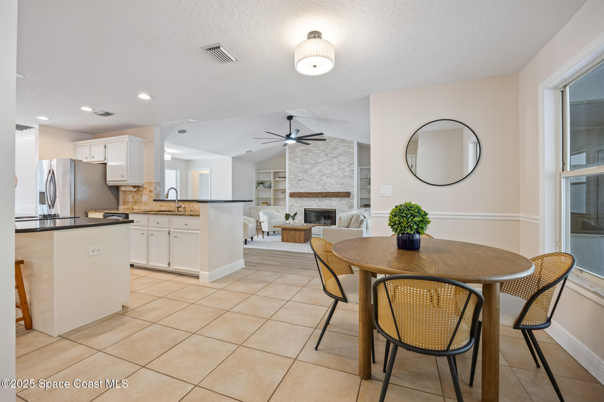 2190 Winston Drive Cocoa, FL 32926 - Photo 16 of 59 a kitchen with granite countertop cabinets a table and chairs in it