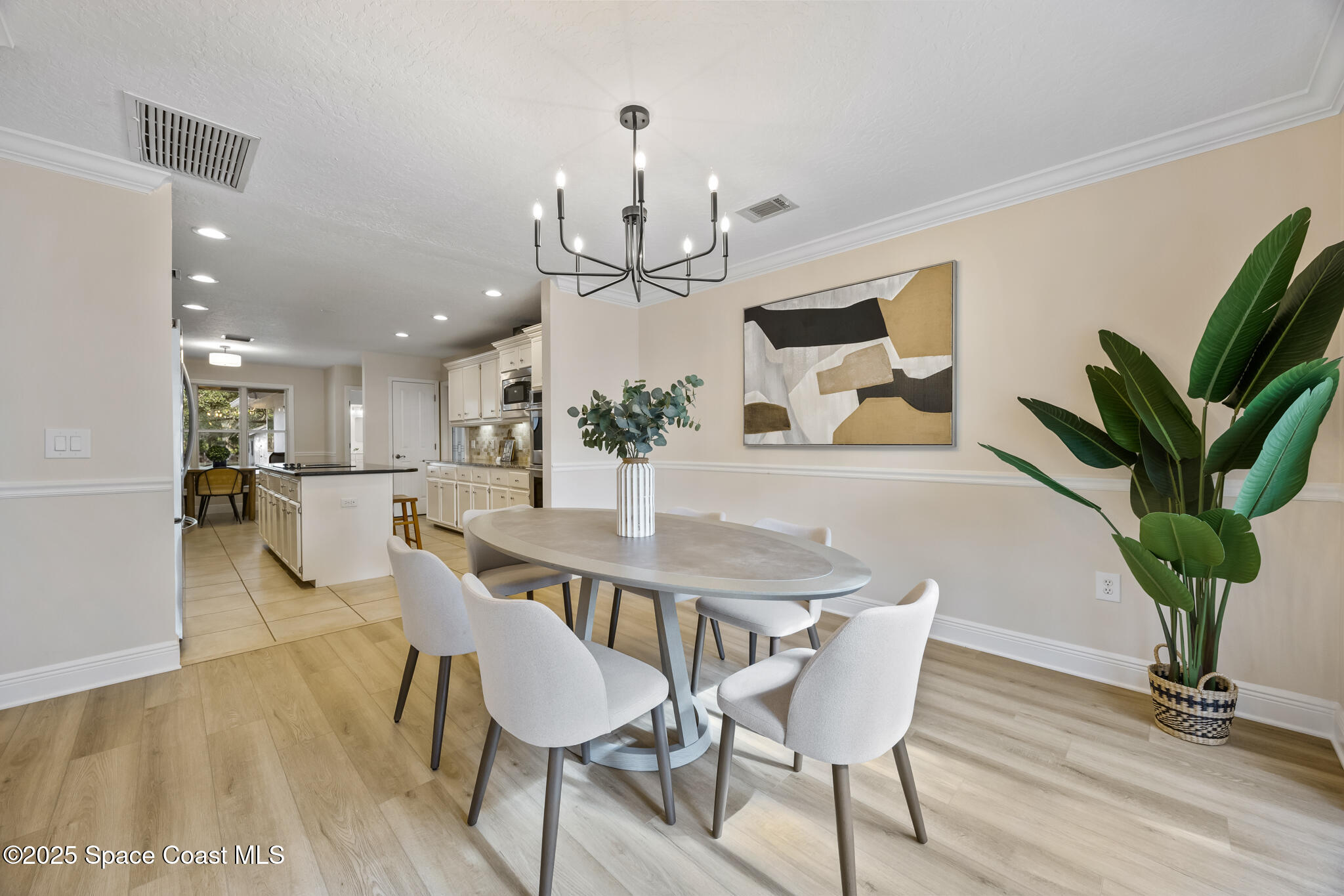 2190 Winston Drive Cocoa, FL 32926 - Photo 18 of 59 a view of a dining room with furniture and a chandelier