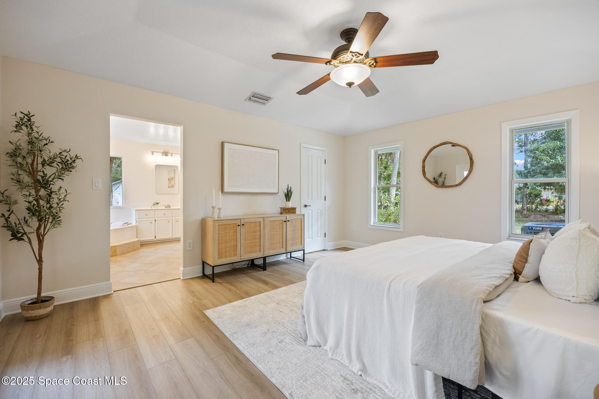 2190 Winston Drive Cocoa, FL 32926 - Photo 20 of 59 a bedroom with a bed a window and potted plant