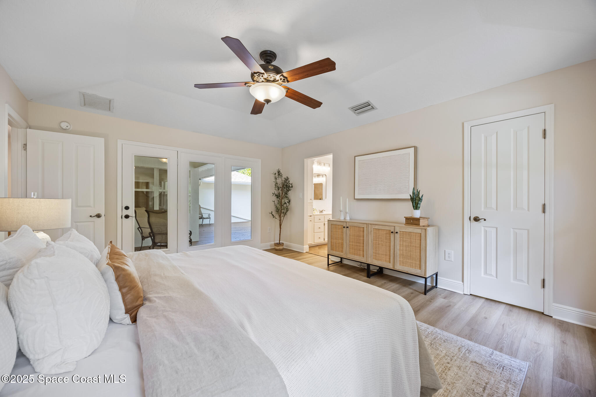 2190 Winston Drive Cocoa, FL 32926 - Photo 21 of 59 a bedroom with a bed and a chandelier