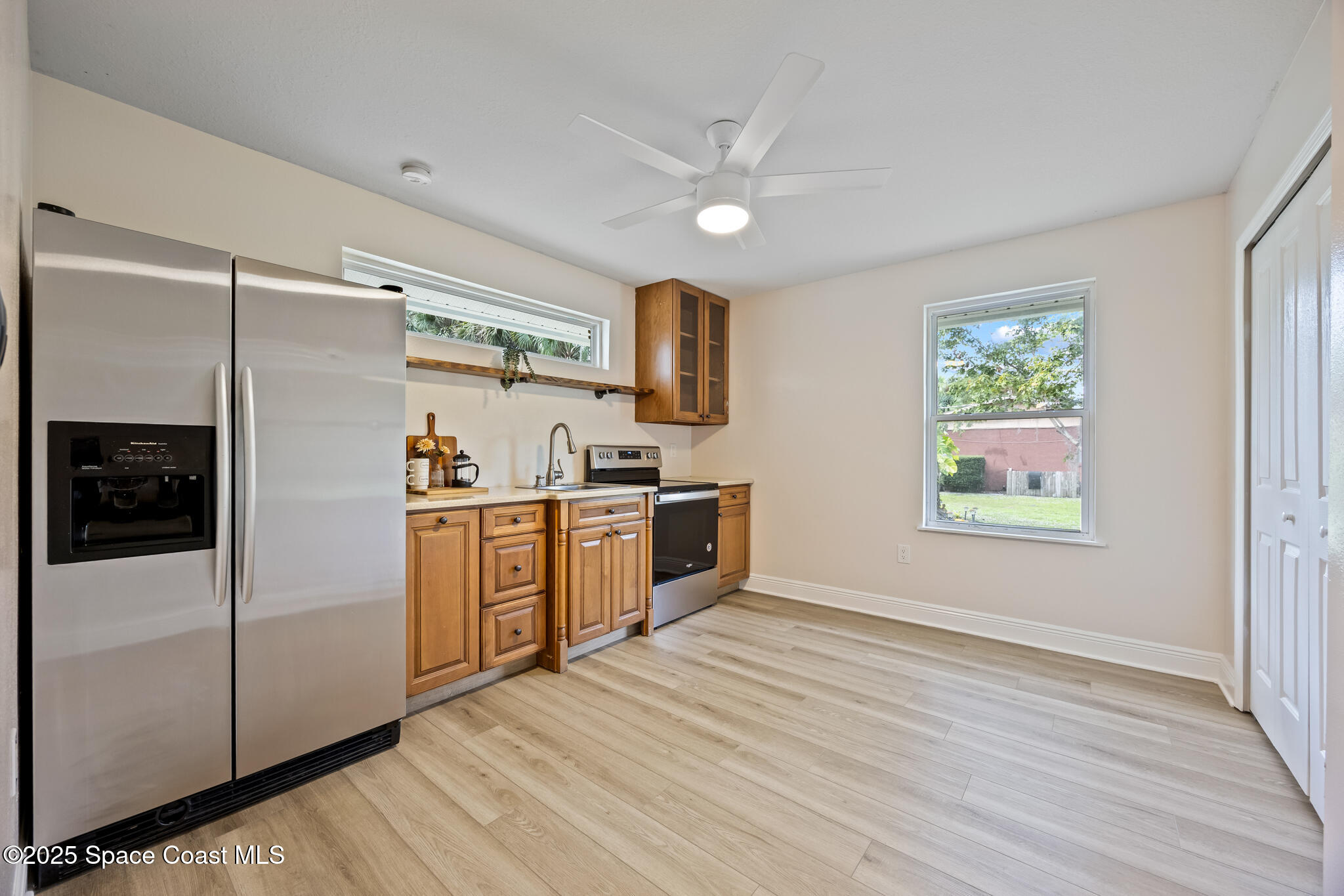 2190 Winston Drive Cocoa, FL 32926 - Photo 30 of 59 a kitchen with a refrigerator a sink and dishwasher with wooden floor