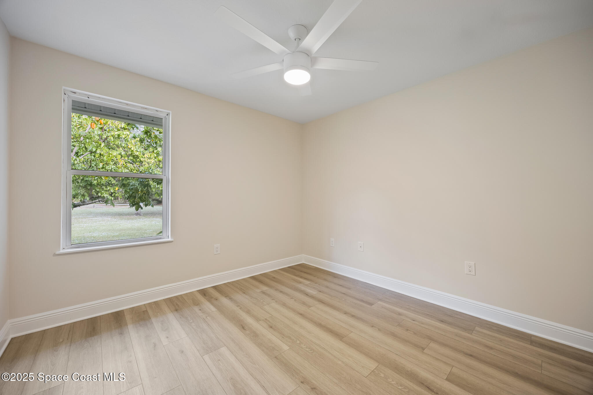 2190 Winston Drive Cocoa, FL 32926 - Photo 34 of 59 an empty room with a window and a ceiling fan