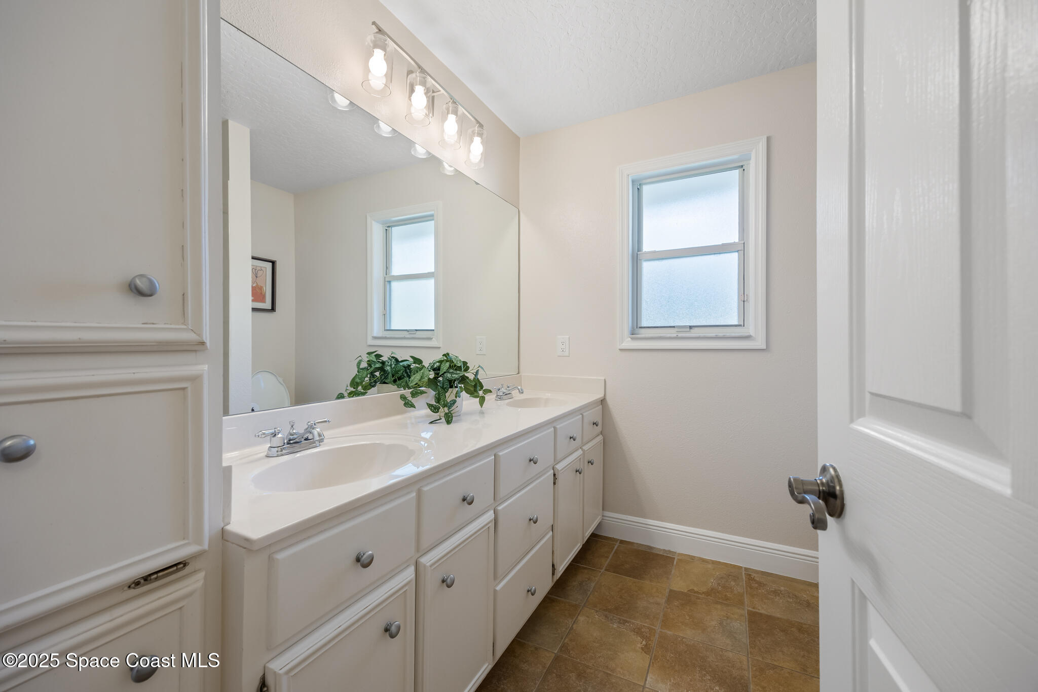 2190 Winston Drive Cocoa, FL 32926 - Photo 35 of 59 a bathroom with a double vanity sink and mirror