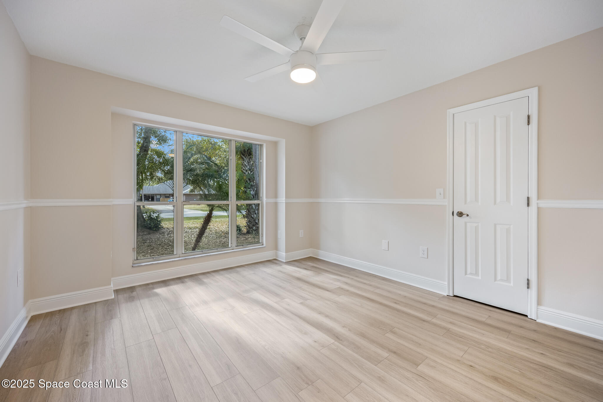 2190 Winston Drive Cocoa, FL 32926 - Photo 36 of 59 an empty room with wooden floor and windows