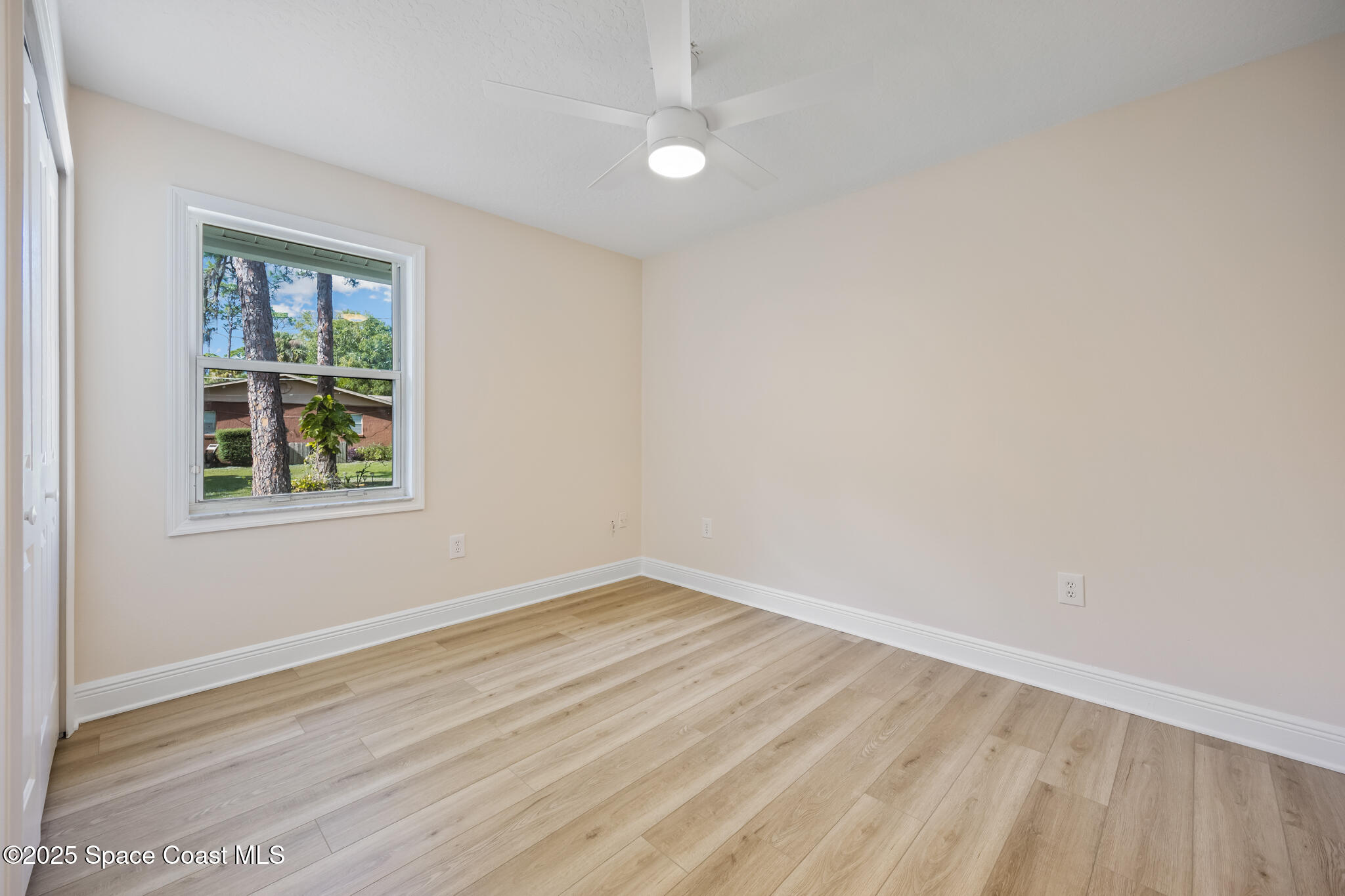 2190 Winston Drive Cocoa, FL 32926 - Photo 38 of 59 an empty room with wooden floor and windows