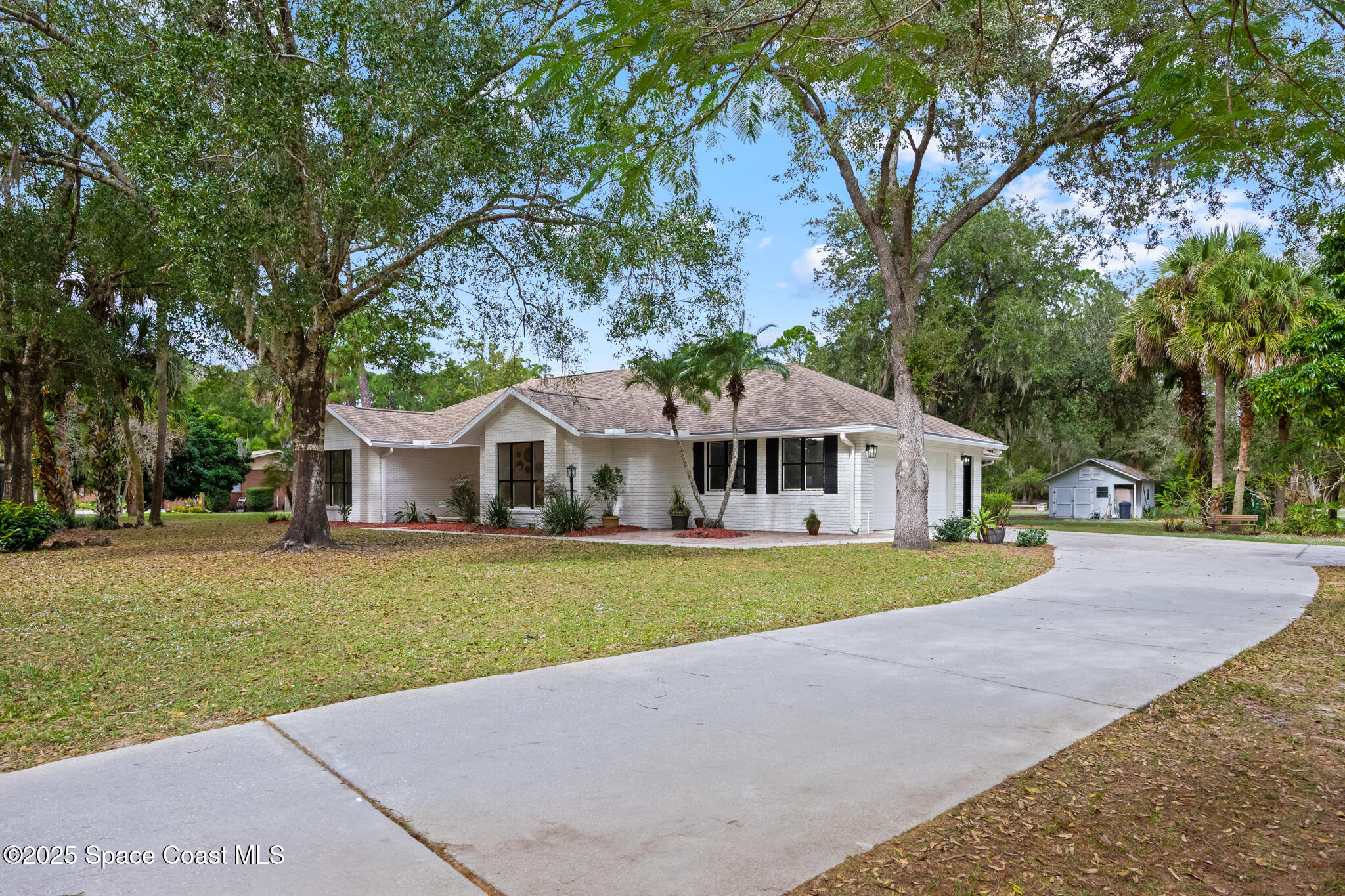 2190 Winston Drive Cocoa, FL 32926 - Photo 4 of 59 a front view of a house with a yard and trees