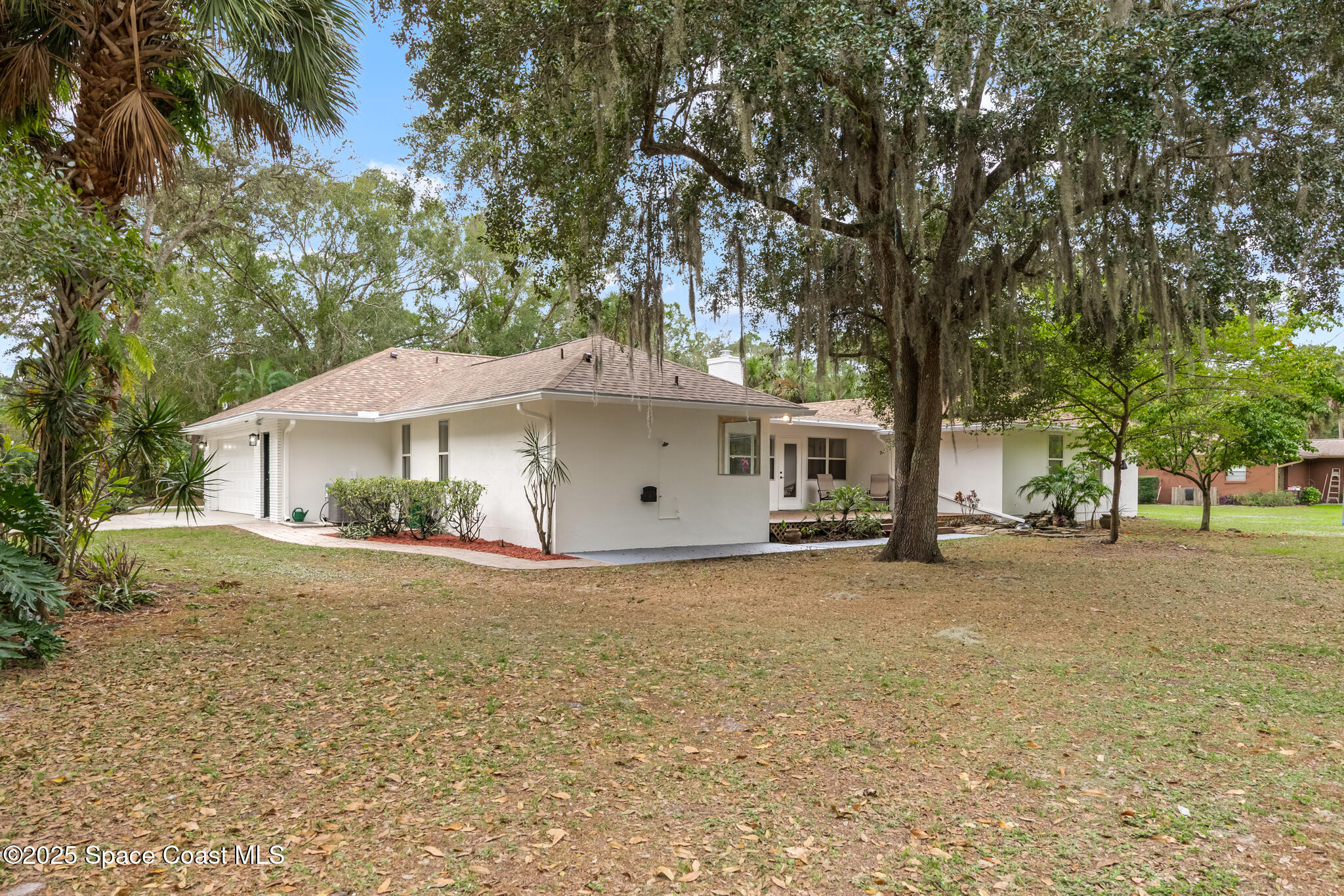 2190 Winston Drive Cocoa, FL 32926 - Photo 42 of 59 a front view of a house with a yard and garage