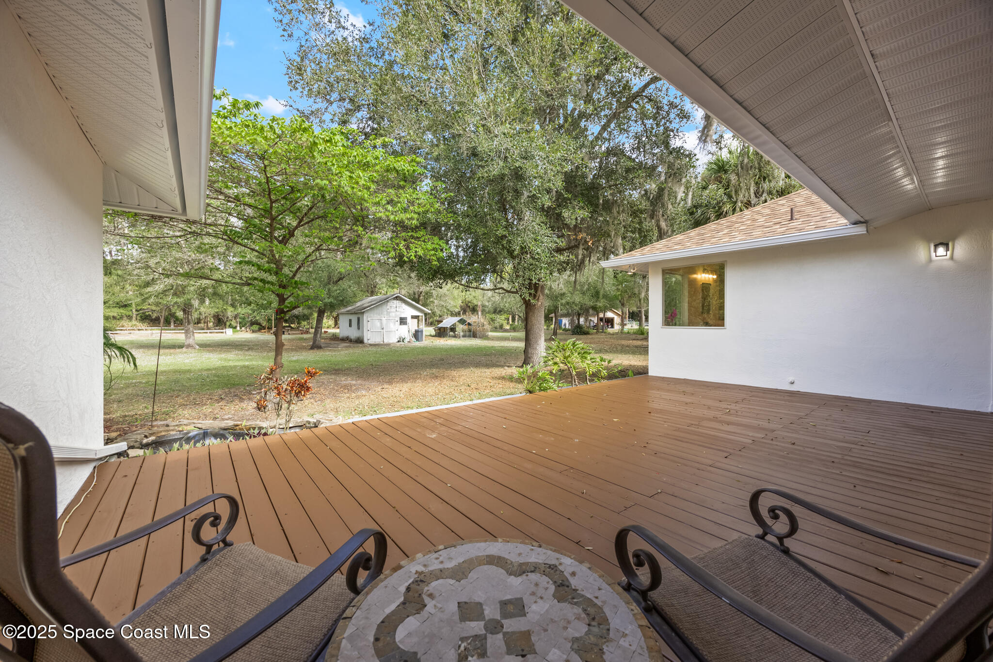 2190 Winston Drive Cocoa, FL 32926 - Photo 45 of 59 a view of a patio with table and chairs with wooden floor and fence
