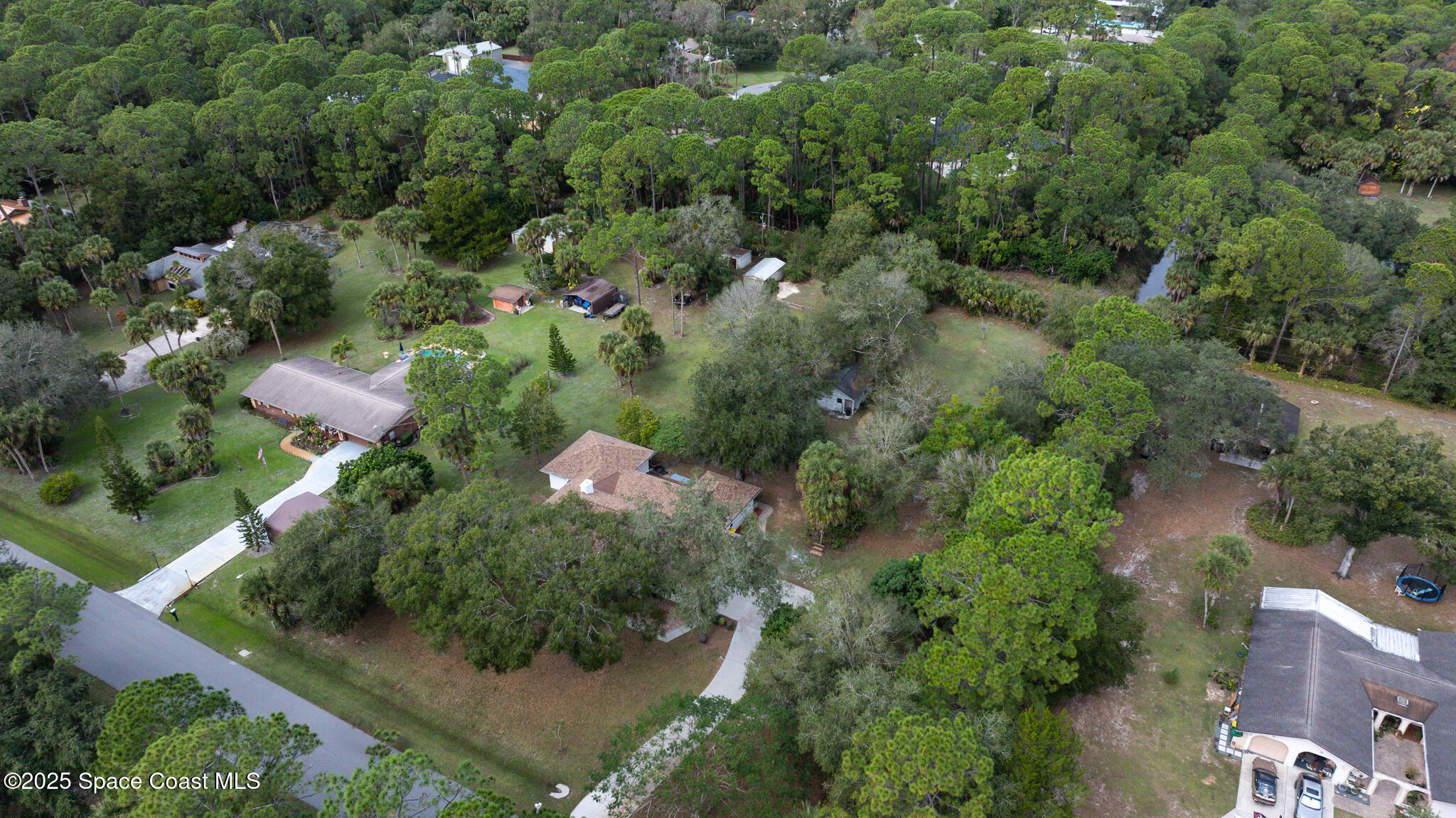 2190 Winston Drive Cocoa, FL 32926 - Photo 53 of 59 an aerial view of residential house with outdoor space and trees all around