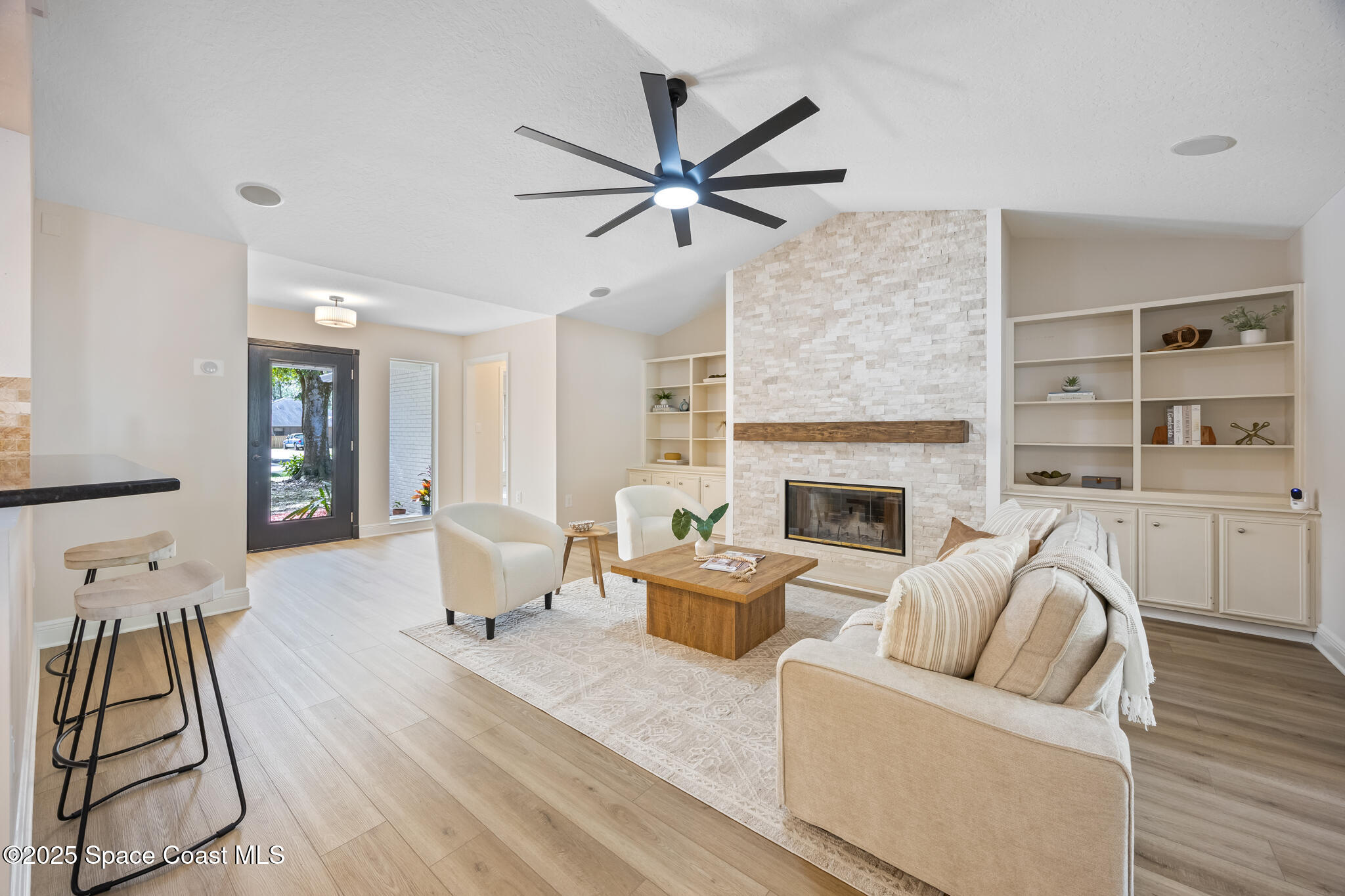 2190 Winston Drive Cocoa, FL 32926 - Photo 8 of 59 a living room with furniture and a fireplace